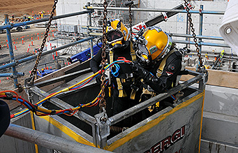 Divers hoisted up by crane | Professional Diving Services